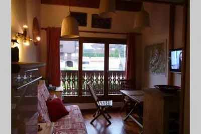 a living room with a view of a balcony at Le Rustica, 3 rooms, 3 stars, 6 people in Les Houches