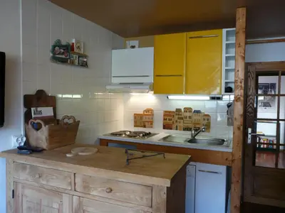 a kitchen with a sink and a stove top oven at Le Rustica, 3 rooms, 3 stars, 6 people in Les Houches