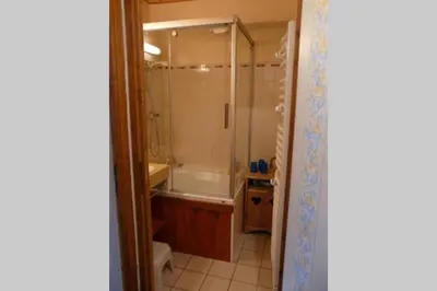 a bathroom with a shower and a sink and a tub at Le Rustica, 3 rooms, 3 stars, 6 people in Les Houches