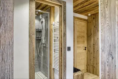a bathroom with a shower and a glass door at Appartement Eskimo in Megève