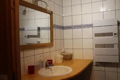 a bathroom with a sink and a mirror at Comfortable Apartment With Terrace In Chamonix in Chamonix-Mont-Blanc