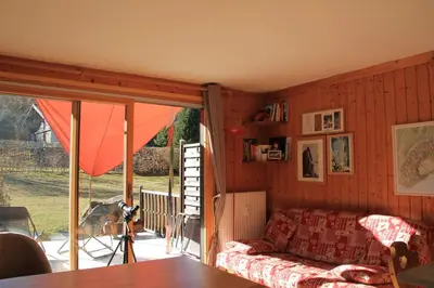 a living room with a couch and a sliding glass door at Comfortable Apartment With Terrace In Chamonix in Chamonix-Mont-Blanc