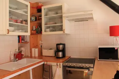 a kitchen with white cabinets and a sink at Comfortable Apartment With Terrace In Chamonix in Chamonix-Mont-Blanc