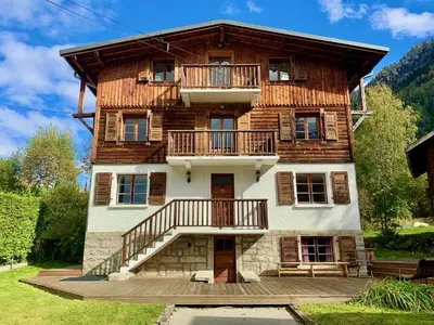 a wooden dresser with a lamp on top of it at Penthouse Apartment, 3 Bedroom with Private Balcony in Chamonix-Mont-Blanc