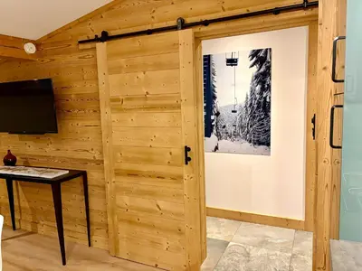 a large wooden house with balconies on the side of it at Penthouse Apartment, 3 Bedroom with Private Balcony in Chamonix-Mont-Blanc