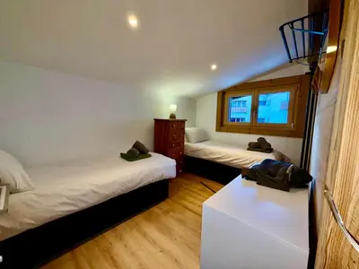 a bedroom with a large bed and a window at Penthouse Apartment, 3 Bedroom with Private Balcony in Chamonix-Mont-Blanc