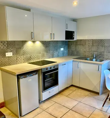 two beds in a room with two windows at 3 Bedrooms, Whole floor, New Kitchen, Town Centre in Chamonix-Mont-Blanc