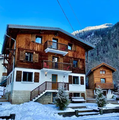 a large wooden building with a balcony in the snow at 3 Bedrooms, Whole floor, New Kitchen, Town Centre in Chamonix-Mont-Blanc
