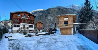 a building in the snow in front of a house at 3 Bedrooms, Whole floor, New Kitchen, Town Centre in Chamonix-Mont-Blanc