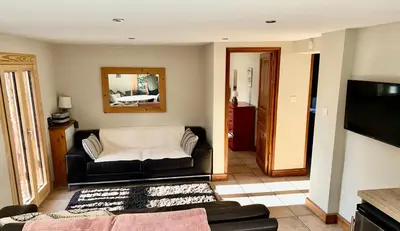 a living room with a couch and a television at 3 Bedrooms, Whole floor, New Kitchen, Town Centre in Chamonix-Mont-Blanc