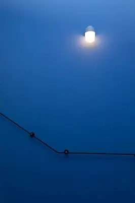 a light on a wire with a blue light at Cosmiques Hotel - Centre Chamonix in Chamonix-Mont-Blanc