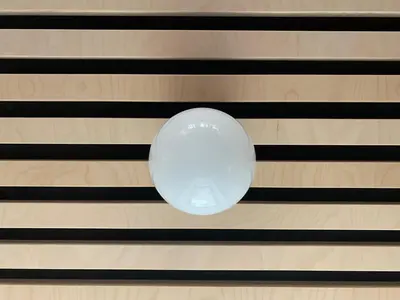 a white ball hanging on a wooden wall at Cosmiques Hotel - Centre Chamonix in Chamonix-Mont-Blanc
