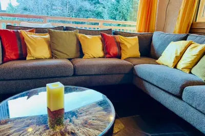 a wooden deck with a couch and chairs on it at Experience Mont Blanc with your family in Chamonix-Mont-Blanc