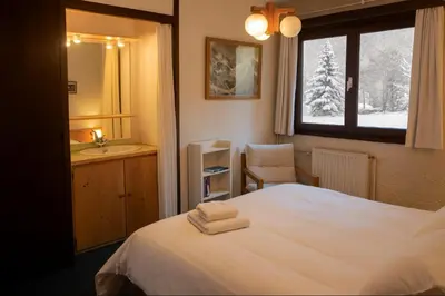 a room with a large window with a mountain view at Experience Mont Blanc with your family in Chamonix-Mont-Blanc