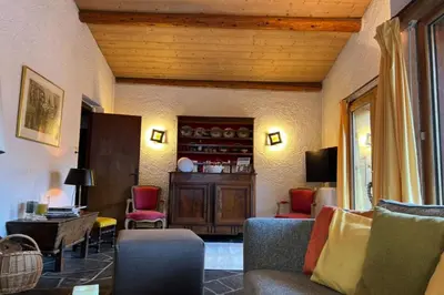a couch with colorful pillows and a candle on a table at Experience Mont Blanc with your family in Chamonix-Mont-Blanc