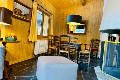 a living room with a couch and chairs and a television at Experience Mont Blanc with your family in Chamonix-Mont-Blanc