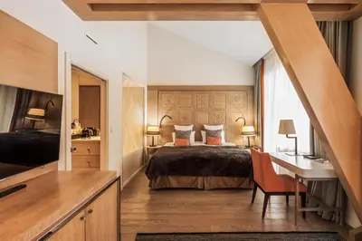 a bedroom with a bed and a desk and a desk at Hôtel Mont-Blanc Chamonix in Chamonix-Mont-Blanc