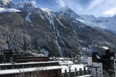 a view of a mountain with snow covered mountains at Hôtel Mont-Blanc Chamonix in Chamonix-Mont-Blanc