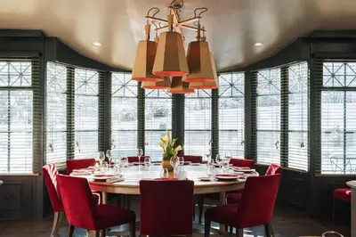 a dining room with a large table and red chairs at Hôtel Mont-Blanc Chamonix in Chamonix-Mont-Blanc