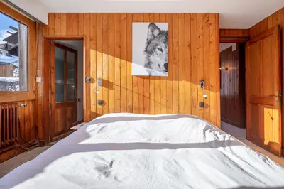 a bedroom with a bed with a picture of a wolf at Chalet Clos 66 in Chamonix-Mont-Blanc