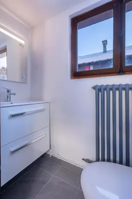 a bathroom with a sink and a radiator at Chalet Clos 66 in Chamonix-Mont-Blanc