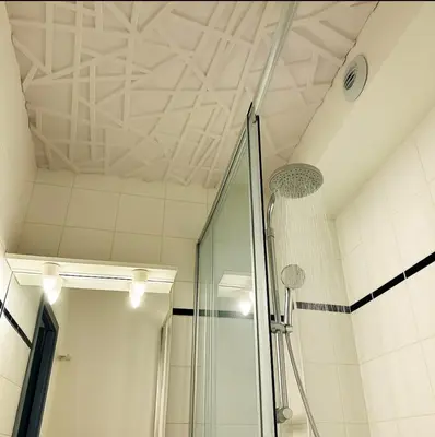 a shower in a bathroom with a ceiling at Cosy Nest Near Center Chamonix in Chamonix-Mont-Blanc