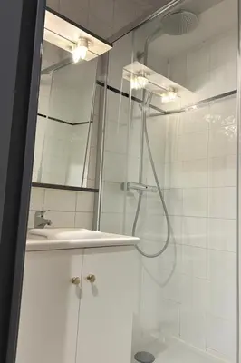a bathroom with a shower and a sink and a mirror at Cosy Nest Near Center Chamonix in Chamonix-Mont-Blanc