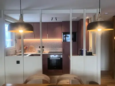 a kitchen with white cabinets and two lights at Résidence Les Planes - Planes 2 MAE-5206 in Saint-Gervais-les-Bains