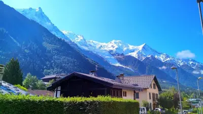 a house with a mountain in the background at Chalet Racar pour 4 personnes, centre ville et vue sur la montagne in Chamonix-Mont-Blanc