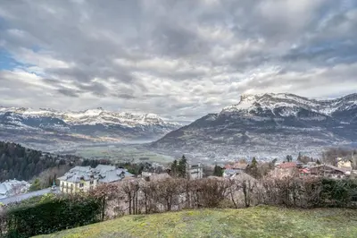 a view of a town with snow covered mountains at Studio Cosy coin-nuit proche centre - Vue splendide in Saint-Gervais-les-Bains