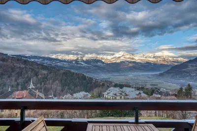 a view of a snowy mountain range from a bench at Studio Cosy coin-nuit proche centre - Vue splendide in Saint-Gervais-les-Bains