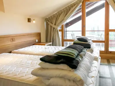 a bedroom with a bed with pillows on it at Private penthouse 2-bed Apartment, ski in and out in 5* Flaine Residence in Flaine