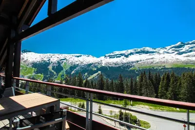 a view from the balcony of a lodge with snow covered mountains at Private penthouse 2-bed Apartment, ski in and out in 5* Flaine Residence in Flaine