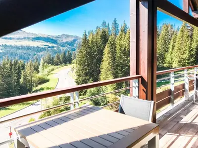 a balcony with a bench and a view of a road at Private penthouse 2-bed Apartment, ski in and out in 5* Flaine Residence in Flaine