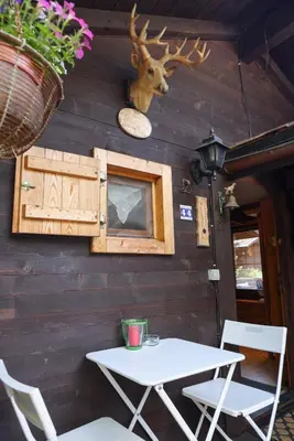 a table and chairs in front of a wall at Le Chalet du Petit Ours in Chamonix-Mont-Blanc