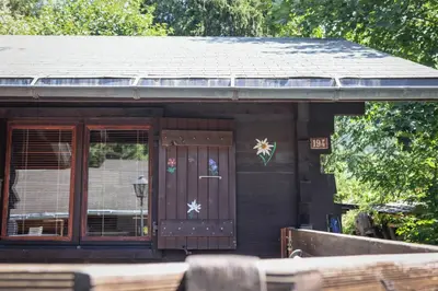 a small brown building with a door and windows at Le Chalet du Petit Ours in Chamonix-Mont-Blanc