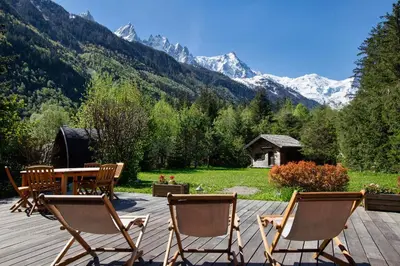 a log cabin in the snow with a mountain at Chalet Les Praz - 280sqm - Sauna Cinema Fitness - 5 Bedrooms in Heart of Les Praz - By Cozee Rentals in Chamonix-Mont-Blanc