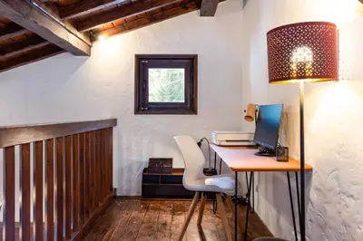 an office with a desk with a computer and a lamp at Chalet Les Praz - 280sqm - Sauna Cinema Fitness - 5 Bedrooms in Heart of Les Praz - By Cozee Rentals in Chamonix-Mont-Blanc