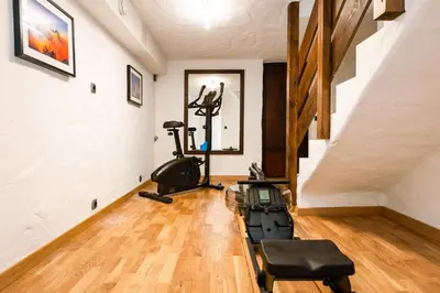 a gym with two exercise bikes in a room at Chalet Les Praz - 280sqm - Sauna Cinema Fitness - 5 Bedrooms in Heart of Les Praz - By Cozee Rentals in Chamonix-Mont-Blanc