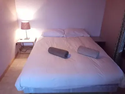a bedroom with a large bed with two pillows at Spacious and comfortable chalet apartment. in Saint-Gervais-les-Bains