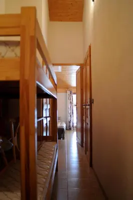 a hallway in a house with wooden doors at Spacious and comfortable chalet apartment. in Saint-Gervais-les-Bains