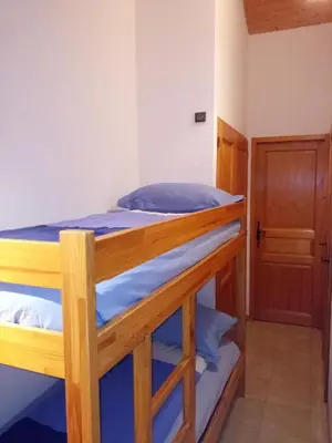 a pair of bunk beds in a room with a door at Spacious and comfortable chalet apartment. in Saint-Gervais-les-Bains