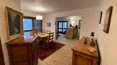 a living room with a table and a dining room at Les Comtes de Savoie - Appartement rénové proche du centre de Megève avec vue sur le Mont d'Arbois in Megève