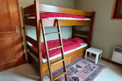 a bunk bed with a ladder in a room at Les Comtes de Savoie - Appartement rénové proche du centre de Megève avec vue sur le Mont d'Arbois in Megève
