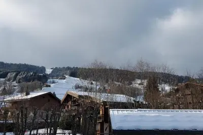 a town with snow on the roofs of houses at Les Comtes de Savoie - Appartement rénové proche du centre de Megève avec vue sur le Mont d'Arbois in Megève