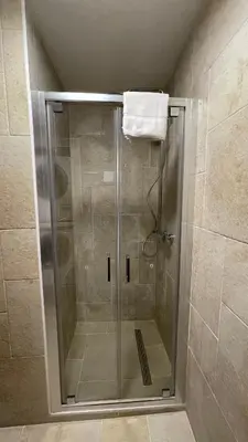 a shower with a glass door in a bathroom at Les Comtes de Savoie - Appartement rénové proche du centre de Megève avec vue sur le Mont d'Arbois in Megève