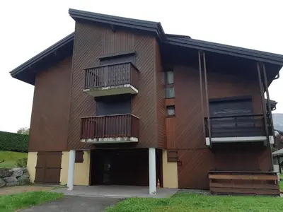 a building with balconies on the side of it at RED APPLE CARROZ Duplex de charme WIFI Parking Balcon TV Ski-Bus in Les Carroz d'Araches