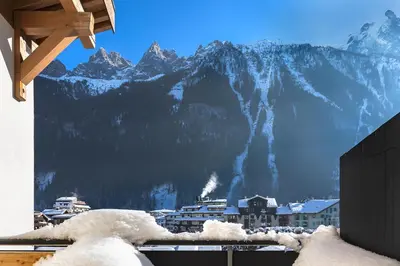 a view of a snow covered mountain from a building at Duplex avec sauna et vue Mont Blanc au centre de Chamonix in Chamonix-Mont-Blanc