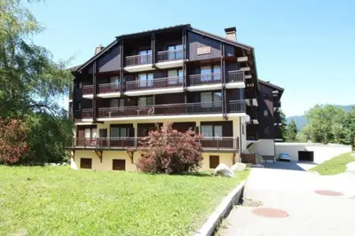 a large building with balconies on the side of it at GREEN APPLE CARROZ Duplex WIFI Garage Balcon-Sud Vue Montagne in Les Carroz d'Araches