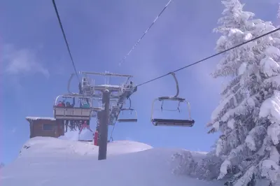 a ski lift with people on it in the snow at Les Carroz Alpine Chalet - central in Les Carroz d'Araches